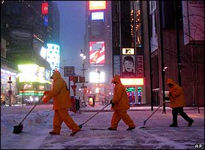 Workers shovel snow from New York's Times Square