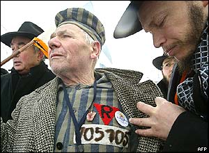 A former Ukrainian prisoner wearing his detention clothes and number arrives with a rabbi at the former Birkenau Nazi death camp