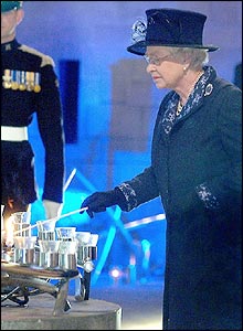 The Queen lighting a candle