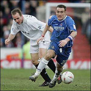 Bolton's Henrik Pedersen and Oldham's David Croft vie for the ball