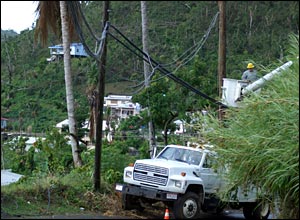 Cuban electricity engineers work on restoring electricity pylons in Grenada