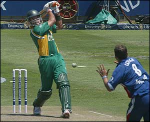 Justin Kemp thumps the ball past Darren Gough