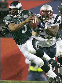 Eagles QB Donovan McNabb is pursued by Patroits linebacker Rosevelt Colvin