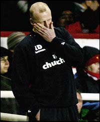 Crystal Palace manager Iain Dowie can hardly watch as his team let in goals at Highbury