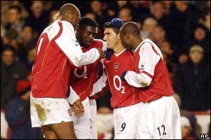 Jose Antonio Reyes is surrounded by his team after getting the second goal in the 35th minute