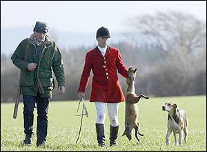 Huntsman holds dead fox