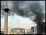 Trafalgar Square with smoke billowing from building 