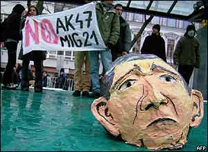 Anti-Bush protesters display their banners and a Bush mask close to the Hviezdoslavovo Square