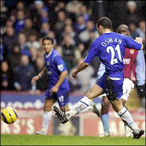 Tim Cahill looks on as Leon Osman scores Everton's third goal