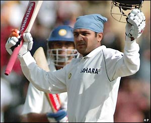Virender Sehwag salutes the crowd after completing his ninth Test century
