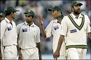 Inzamam-ul-Haq leads his Pakistan players from the pitch at the close