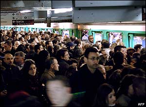 Crowds of people try to get onto the metro in Paris, France