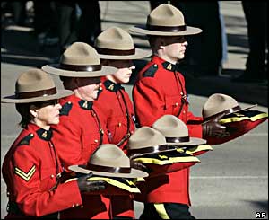 Mounties carry the hats of their fallen RCMP colleagues