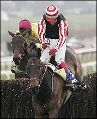 Robert Thornton sits tight as Kelami clears the last fence to take the William Hill Trophy