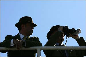 A couple of racegoers wait for the action to start