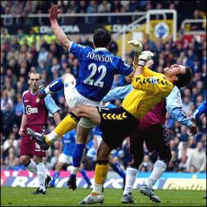 Villa goalkeeper Thomas Sorensen is shunted to the ground as he challenges Birmingham's Damien Johnson