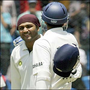 India's Virender Sehwag is hugged by Rahul Dravid after scoring a century