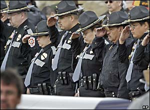 Police salute the coffin of former officer Daryl Lussier, grandfather of Jeff Weise