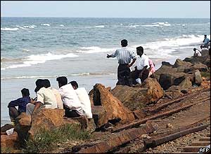 Sri Lankans look out to sea following the Indonesian earthquake