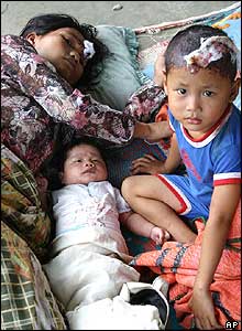 A mother with her two young children at a temporary shelter in Nias