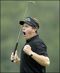 Mickelson celebrates after holing the putt on the last