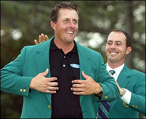 Mickelson is presented with the green jacket by 2003 Masters winner Mike Weir 