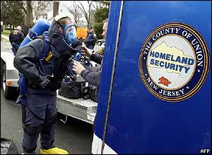A bomb squad officer gets into his protective suit