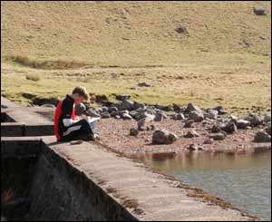 Steve Williams' son James sketching the mountains and lake at Llyn-Y-Fan Fach 