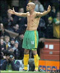 Norwich striker Leon McKenzie shows off his physique after the match-clinching goal