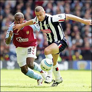 Vassell closes down Baggies defender Neil Clement at Villa Park