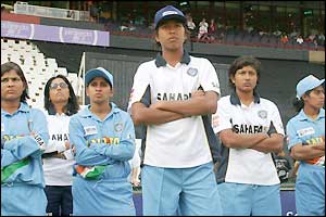 India's disappointed players look on as Australia collect the trophy