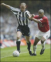 Newcastle's Nicky Butt holds off Manchester United's Quinton Fortune