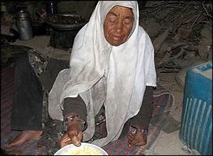 Woman offers corn to locals in village