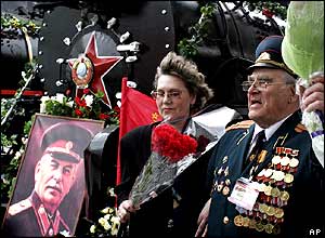 A WWII veteran addresses a rally in Moscow. The portrait of Josef Stalin is seen at the front of a locomotive, as in 1945.