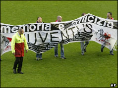 Liverpool fans hold banner in Italian reading 