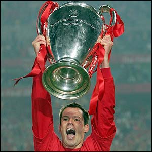 Liverpool's Jamie Carragher holds the Champions League trophy