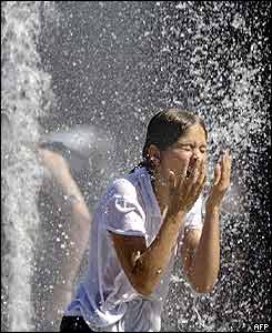 A girl stands under a fountain in Hanover, Germany