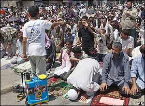 Shia Muslims are sprayed with water in Baghdad, Iraq