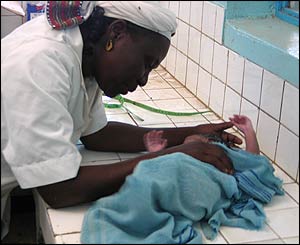 Grace Kodindo examining a baby