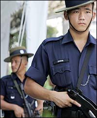 Security personnel patrol outside Raffles City in Singapore