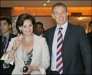 Tony Blair with his wife Cherie outside the Swissotel in Singapore