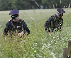 Police search a field