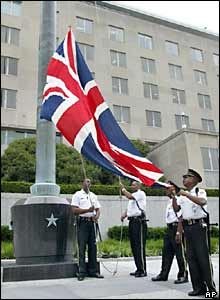Police officers raise a union jack in front of the State Department in Washington DC, in remembrance of those killed in the London bombings.