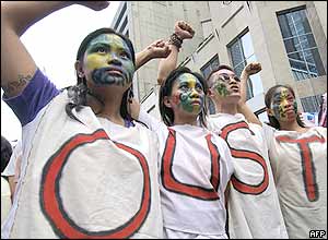 Protesters take part in a mass demonstration calling on Philippine President Gloria Arroyo (GMA) to resign, in the Makati financial district of Manila, 13 July 2005