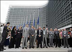 European commissioners bow their heads in front of the EU Headquarters in Brussels