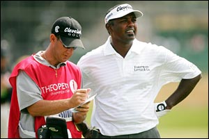Vijay Singh chats with his caddy