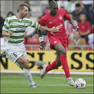 Liverpool striker Djibril Cisse outpaces TNS defender Tommy Holmes before giving his side the lead