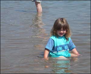 A photo of Caitlin Thomas-Burton enjoying the sea at Newquay in Ceredigion, as sent by her grandad Lewis Thomas