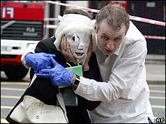 Man with arms round woman with face covered by mask