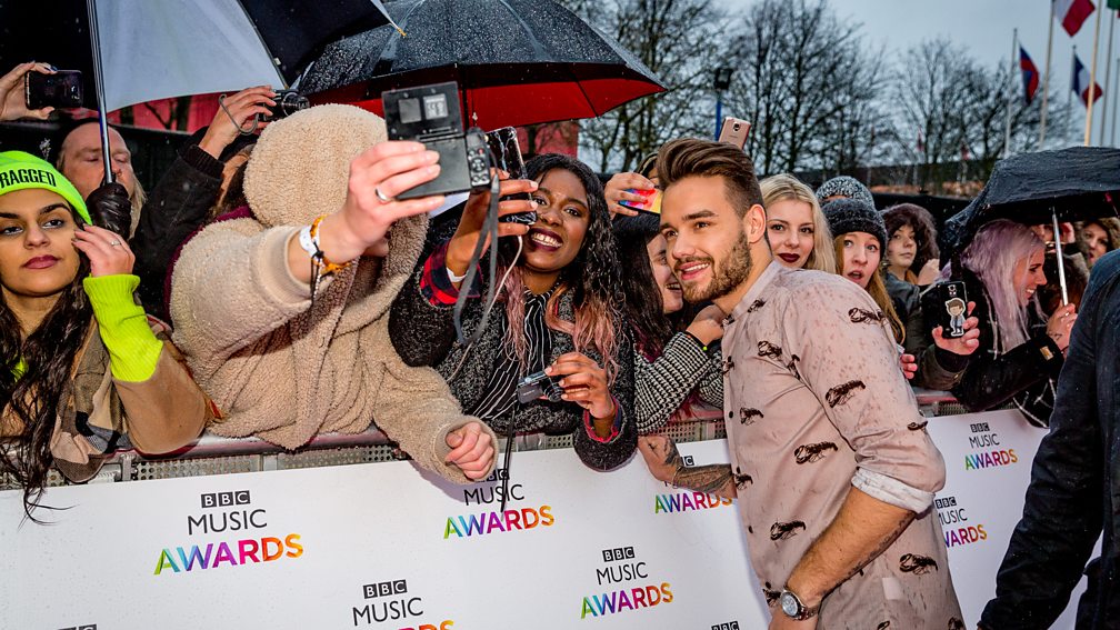 The boys posing with Directioners before the BBC Music Awards 2015